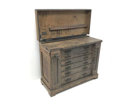 Late 19th century work bench tool cabinet, hinged lid enclosing tool rack, single vice, six graduating drawers, storage cupbo