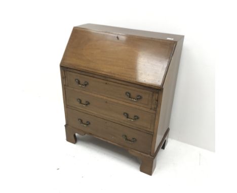 Edwardian inlaid mahogany bureau, fall front enclosing fitted interior, three graduating drawers, shaped bracket supports, W7