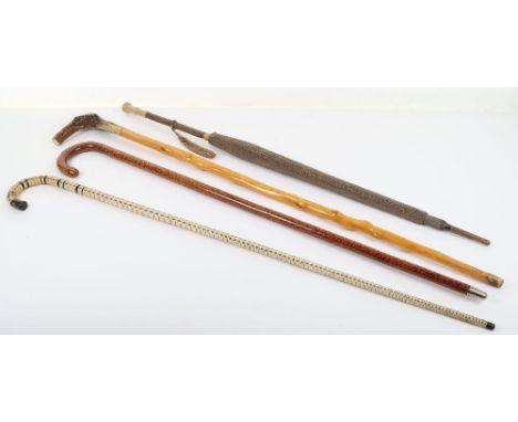 A group of walking canes and sticks, including a shark verterbrae stick, a fine ladies Edwardian parasol and cover, (4)