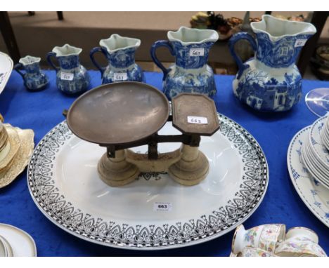 A large pottery oval meat platter in Hawthorne pattern, a pair of scales and a set of five graduated pottery jugs Condition R