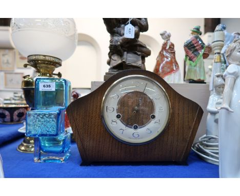 A blue art glass vase and a wooden mantle clock Condition Report: Available upon request