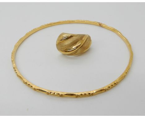 A bright yellow metal bangle, and a single 18ct gold earring, combined weight 14.8gms Condition Report: Available upon reques