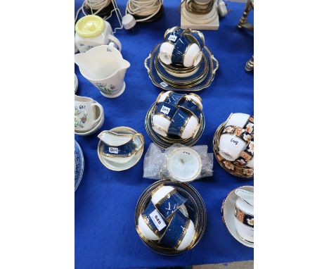 An Aynsley teaset with mottled blue band with gilt decoration comprising milk jug and sugar bowl, twelve cups, saucers and pl