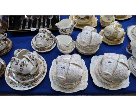 A Minton Petunia pattern teaset designed by John Wadsworth comprising eleven cups, twelve saucers, plates, two cake plates, m