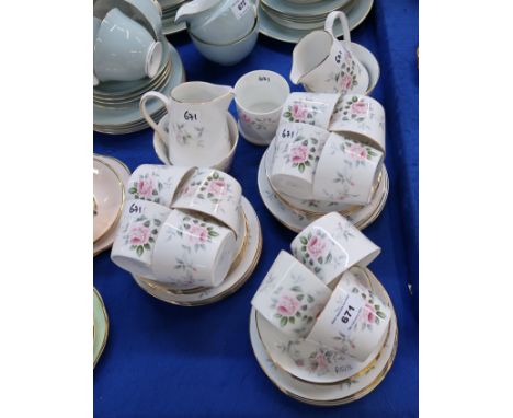 A Royal Tuscan rose decorated teaset comprising eleven cups, twelve saucers, plates, two milk jug sand sugar bowls and a jam 