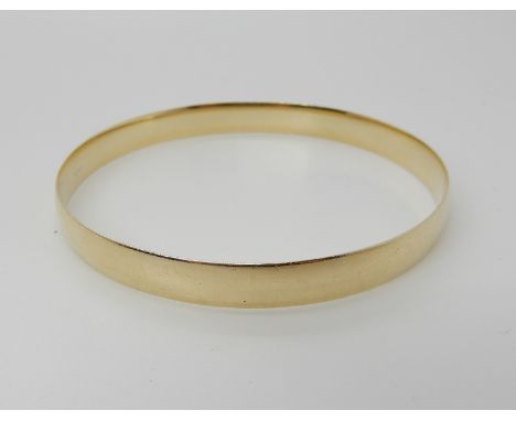 A yellow metal bangle, weight 18.5gms Condition Report: Available upon request
