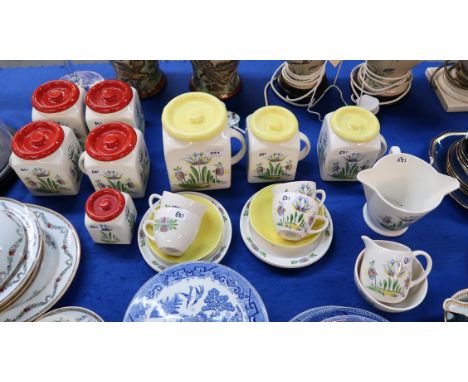 A collection of Old Bristol Delft pottery including three yellow topped storage jars, five red topped storage jars, four cups