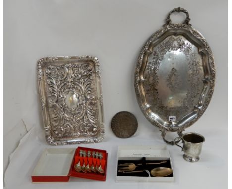 A lot comprising two silver plated trays, an EP christening mug, a peacock plaque and two small cased spoon, knife and fork s
