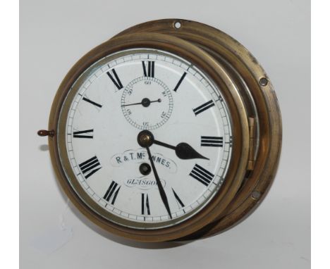 A brass cased bulkhead clock, R &amp; T. McInnes, Glasgow, 20cm diameter and a pair of Hoya binoculars in case Condition Repo