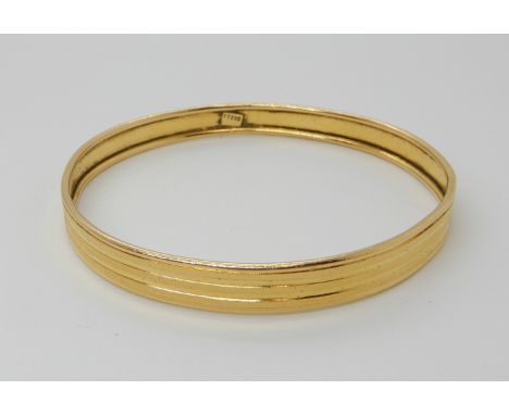 A bright yellow metal bangle stamped k22, weight 18.5gms Condition Report: Available upon request