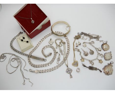 A heavy silver curb link chain, silver bangle, silver medallions etc Condition Report: Not available for this lot