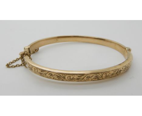 A 9ct gold engraved bangle weight 8.4gms Condition Report: Available upon request