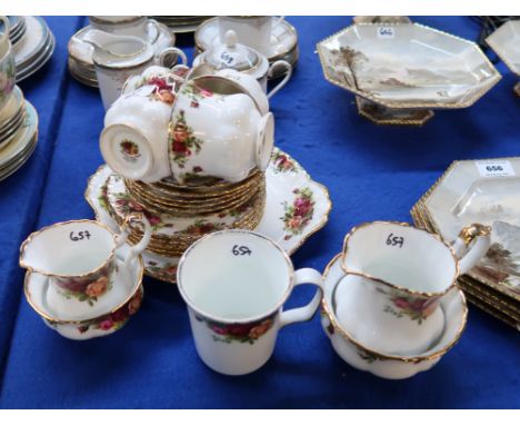 A Royal Albert Old Country Roses teaset comprising four cups, six saucers and plates, cake plate, two milk jugs and sugar bow