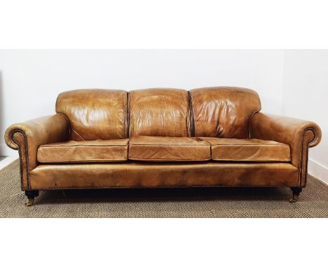 SOFA, in brown leather triple hump, 215cm W x 107cm D x 75cm H.