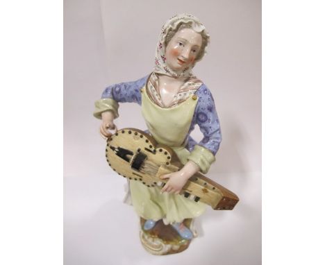 A DRESDEN FIGURE 19th Century modelled as a female playing a musical insturment shown standing on a roccoo base 33cm high