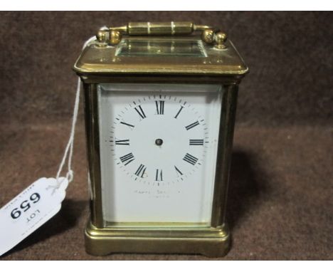 A BRASS CARRIAGE CLOCK with enamel dial