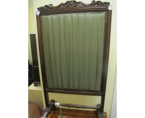 A WILLIAM IV ROSEWOOD FIRESCREEN the rectangular frame with carved cresting above a silk adjustable panel on standard end sup