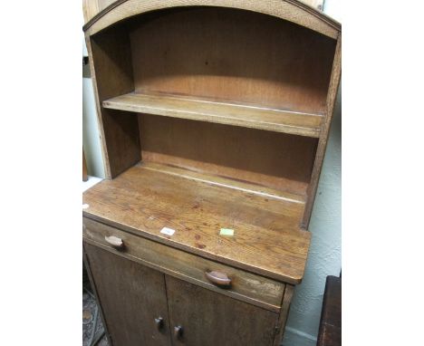 AN OAK WELSH DRESSER the arched super structure with moulded shelf the base with one long drawer and cupboards on platform su