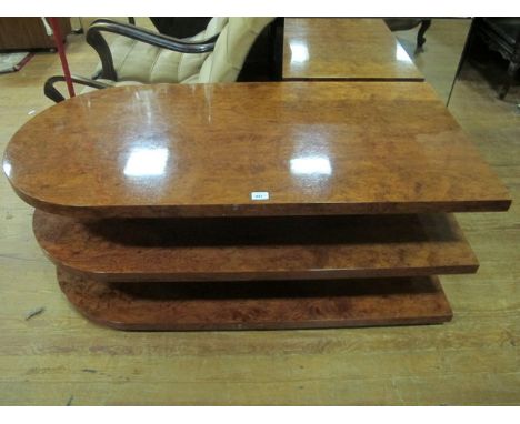 A VERY FINE ART DECO STYLE WALNUT THREE TIER TABLE of rectangular D-shaped outline the shaped moulded top above two open shel