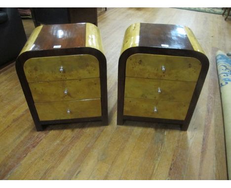 A PAIR OF ART DECO STYLE WALNUT AND ROSEWOOD CHESTS each with a shaped moulded top above three frieze drawers raised on block
