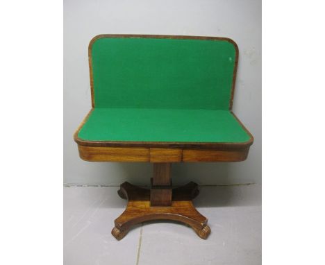 A GOOD REGENCY ROSEWOOD FOLD OVER CARD TABLE the rectangular hinged top containing a baized lined interior above a moulded fr