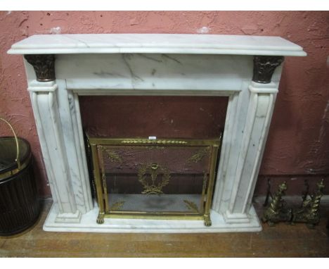 A WHITE VEINED MARBLE CHIMNEY PIECE the rectangular shelf above a plain frieze raised on panelled jabs headed with brass cori