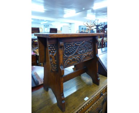 A carved oak box stool 