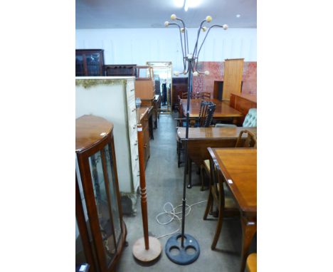 A teak standard lamp and cast iron mid 20th Century coat stand 