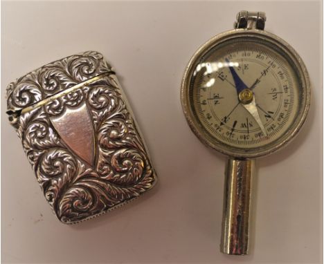 A silver vesta case, repousse foliate design; an early 20th century compass (2)