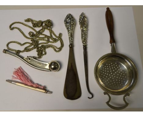 A sterling silver propelling pencil; a silver button hook and shoe horn; a bosun's whistle; an E.P.N.S tea strainer (5)