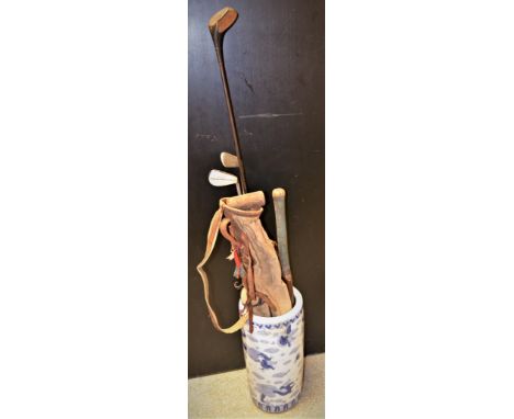 A Slazenger Gradidge Len Hutton cricket bat; early 20th century golf bags; golf clubs, etc, all stood in Chinese blue and whi