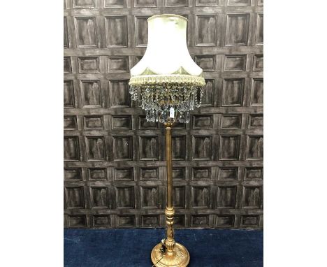GILDED WOOD STANDARD LAMP, with a fringed shade above rows of prismatic drops, 197cm high