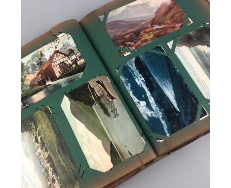 ALBUM OF VINTAGE POSTCARDS, landscape views, some military encampment views, contained in a cloth bound album