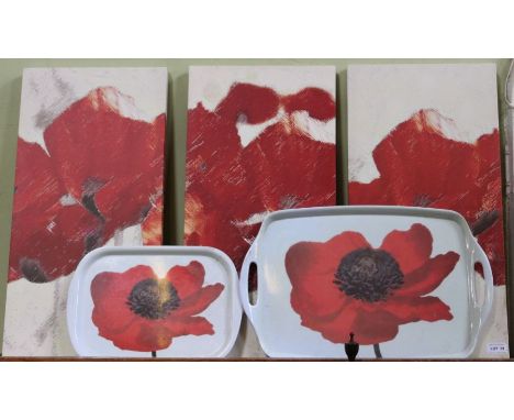 Three modern graphic canvas prints of stylised poppies together with two poppy trays 