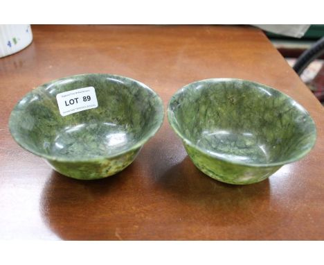 A pair of Chinese spinach green jade bowls, 12cm in diameter