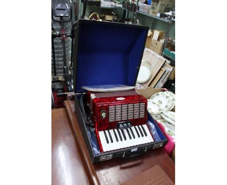 A cased Bell 32 key accordion with 3 selectable voices with doc's