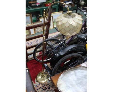 A Brass standard lamp with flower head shade