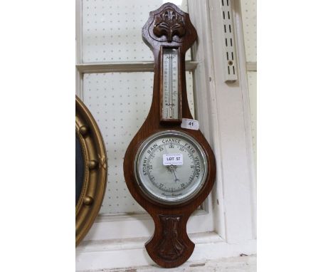 A wall mountable oak backed Barometer thermometer