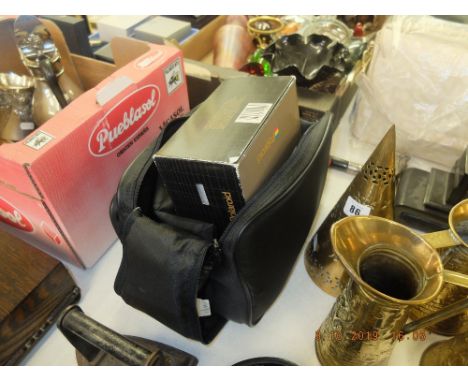 A boxed polaroid camera and case