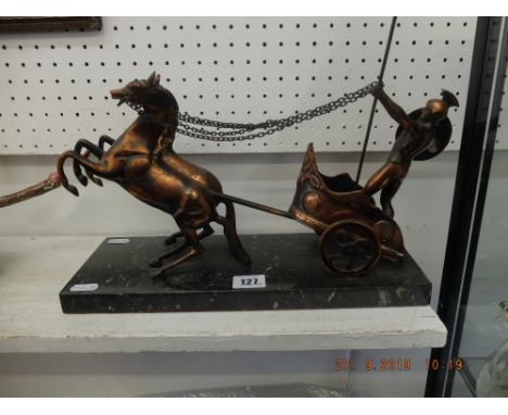 A cast metal sculpture of a Roman chariot on marble plinth