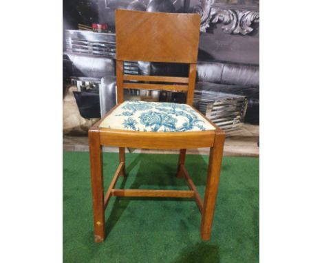 An English oak Art Deco single chair. The mirror veneered back above a drop in fabric covered seat, on square legs with H-for