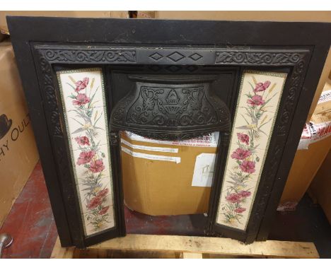 A Victorian Style  cast iron black fire surround decorated with Poppy &amp; Wheatsheaf  ceramic tiles with a scroll siamond m