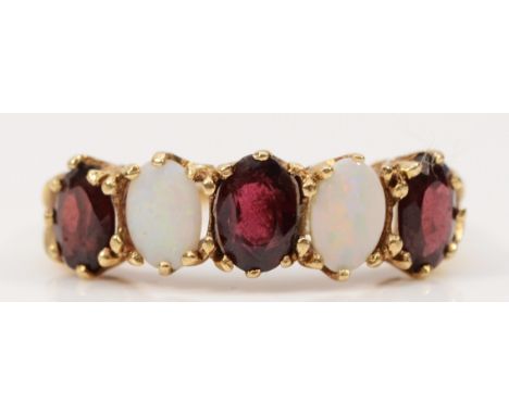 A 9ct gold opal and garnet five stone ring, P, 2.6g