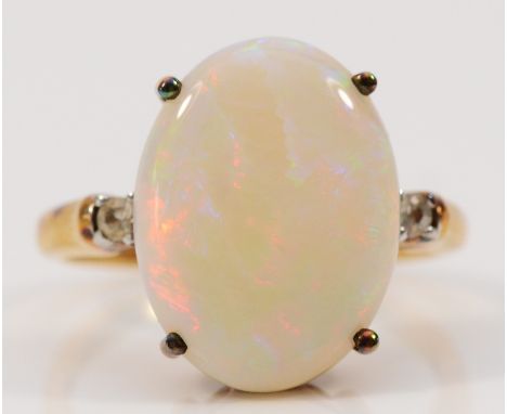 A 9ct gold opal and white gemstone dress ring, 16mm x 12mm opal, N, 3.6g