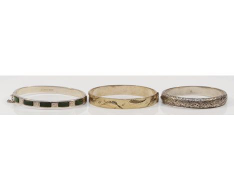 A silver hinged bangle, exposed hallmarks London 1977, Jubilee duty mark, 62 x 52mm and two other silver bangles, 48gm
