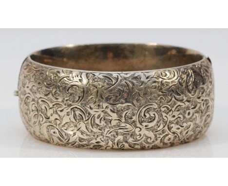 A vintage unmarked silver hinged bangle, 58 x 47mm, 25mm wide, 54gm