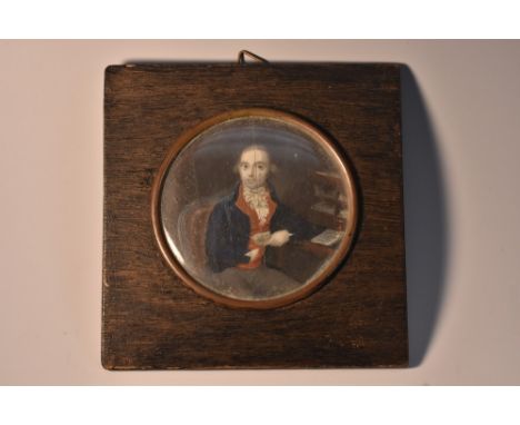 French School (19th century), a portrait miniature, of a gentleman at his papers, watercolour on ivory, circular, 7.5cm diam