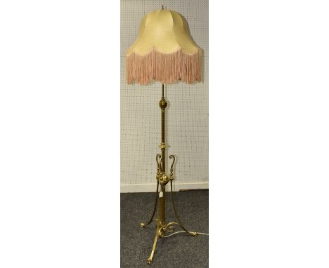 An early 20th century brass standard lamp, the central column knopped throughout with girdles and terminating in a globular r