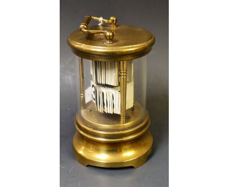 An early 20th century lacquered brass and glass bracket ticket or Plato clock, swing carrying handle, shaped base, 17cm over 