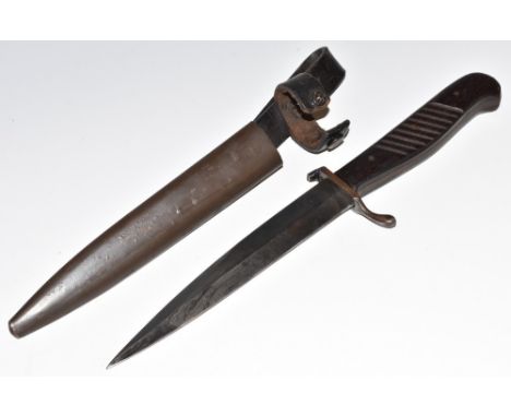 A World War I German trench fighting knife, 14.5cm blade, curved crossguard with single quillon, ribbed two-piece wooden grip